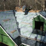 An image of underlayment being installed all over a roof