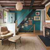 living room with fireplace with door entryway and staircase