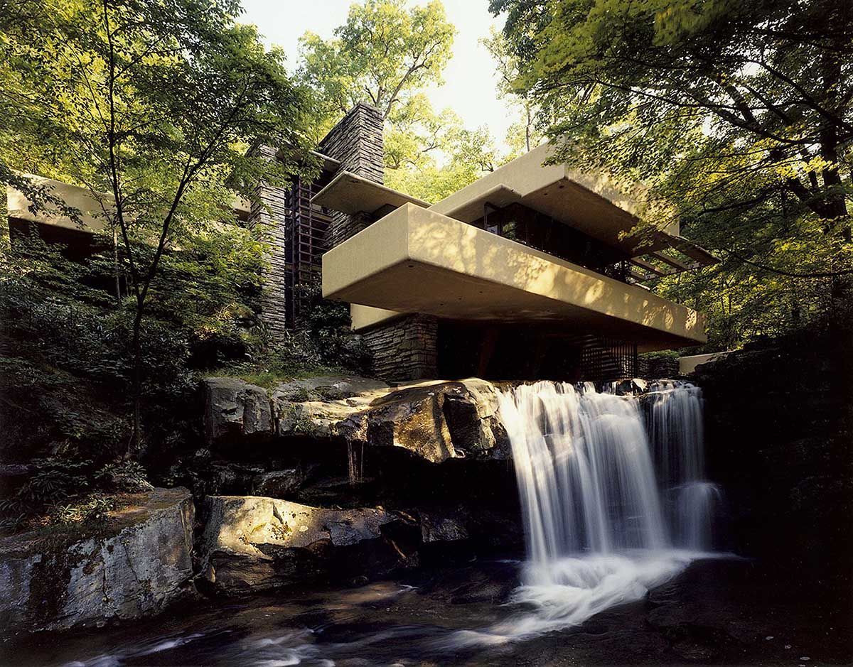 Fallingwater in Summer-Courtesy of the Western Pennsylvania Conservancy Located in Mill Run, Penn., Frank Lloyd Wright's Falling Water (1935) is considered to be one of the greatest architectural triumphs of the 20th century. Built over a waterfall, the cantilevered house is gripping for the way in which it integrates with the surrounding forested lot. The interior-exterior connection was a major design-driver of midcentury-modern architecture. Photo courtesy of the Western Pennsylvania Conservancy.