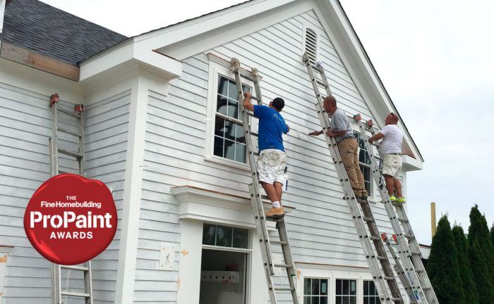 someone painting a house