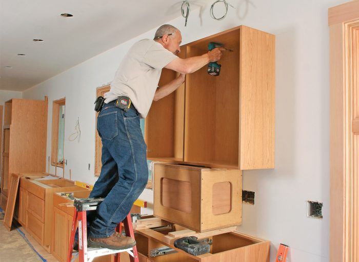 installing kitchen cabinet brick wall