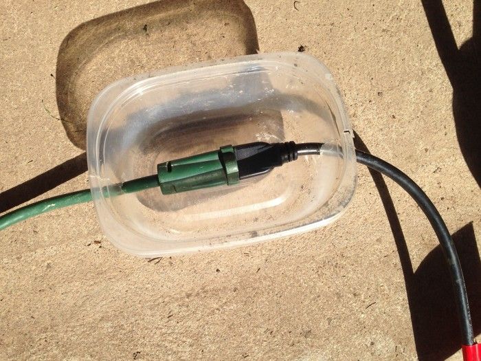 Homemade extension cord plug protection for a wet environment