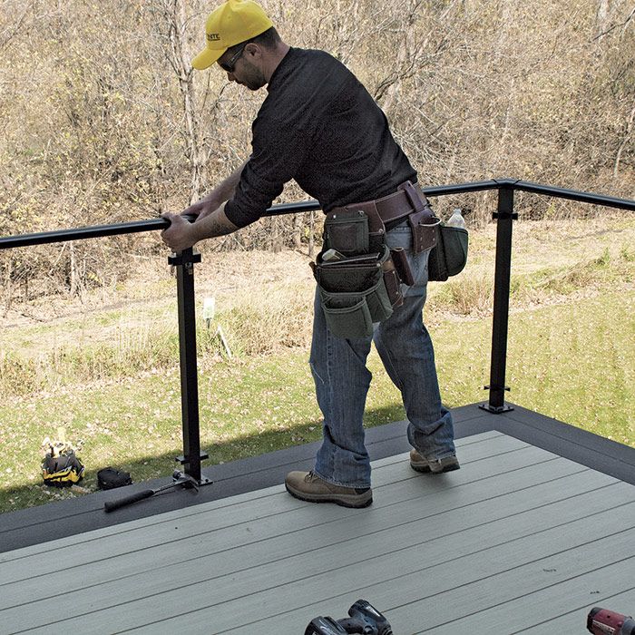 15. install perimeter handrail. Cut the handrail to the needed length. Using the flex provided by the looseness of the corner posts, slip the handrail into the cap atop the corner post.