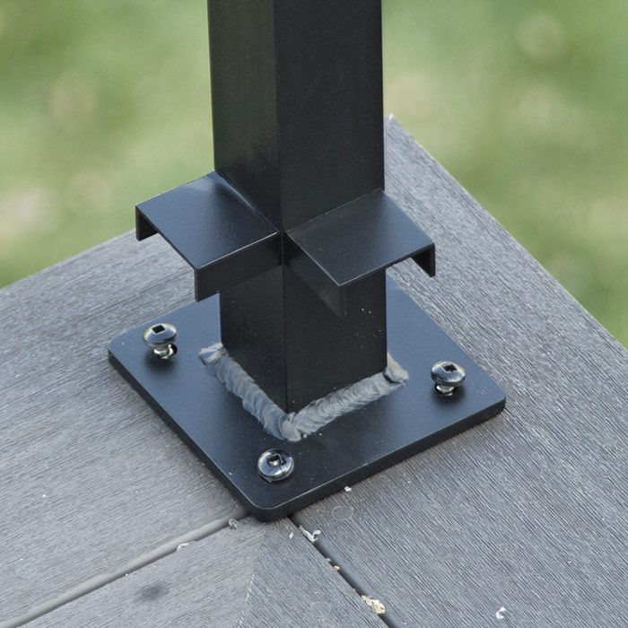 12. Install the corner posts. Working around the perimeter of the deck, install the corner post 2 in. in on both sides from the deck edge. Leave the fasteners loose so the post can be tipped to accept the rail. Fasten the corner cap onto the post.