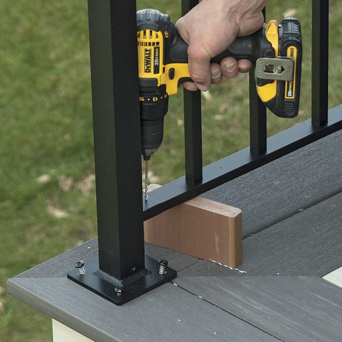 11. Fasten the balustrade. At each bracket, drill holes and install fasteners to hold the balustrade in place. Remove the positioning scrap and retighten the screws on the post bases.