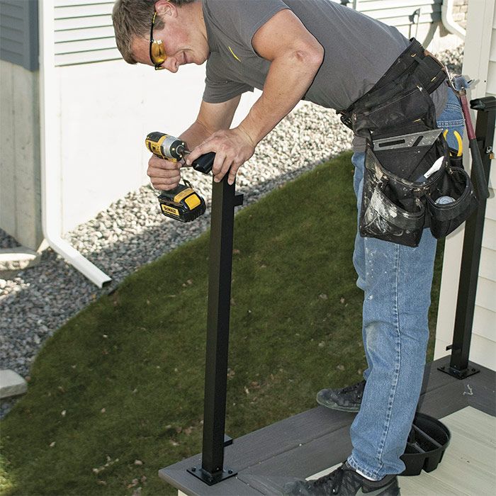 6. Attach the post bracket. Install the post top bracket. In this instance, the cap makes the transition to the stair railing. (See step 14 for the type of bracket used midway in a run of railing.)