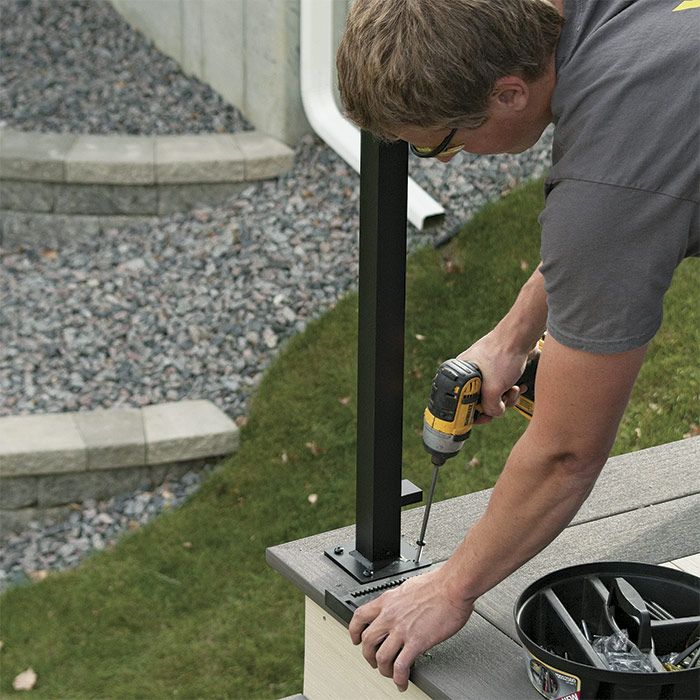 5. Attach the post base. Using the powder-coated fasteners provided with the railing, attach the post to the deck. For greater holding strength, slightly angle the fasteners toward the center of the post.
