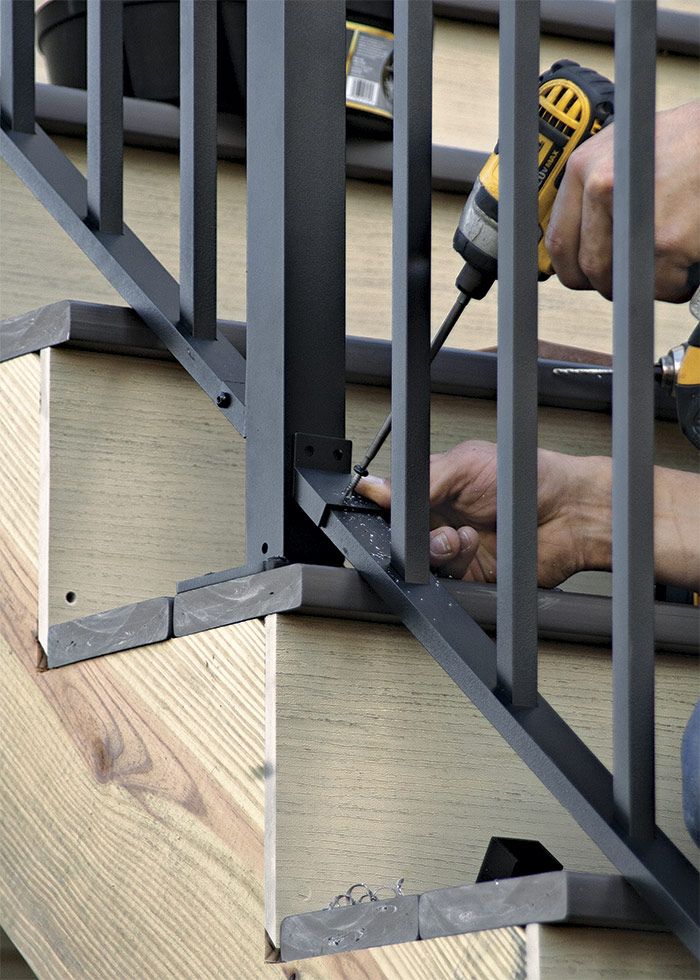 24. Install the balustrade brackets. Measure and cut the sections of balustrade. Resting the balustrade on the nose of the treads, slip brackets onto each bottom bracket, push it against the post, and fasten.