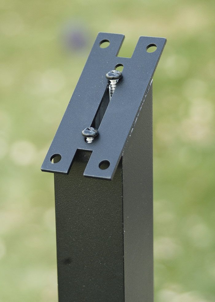 21. Install post brackets. Attach a handrail bracket to each post. In this case, the screws fasten to an extruded channel in the post.