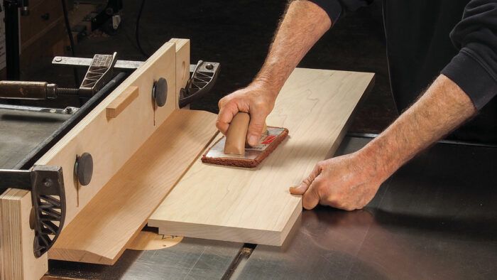 A rabbet is being cut at the table saw.